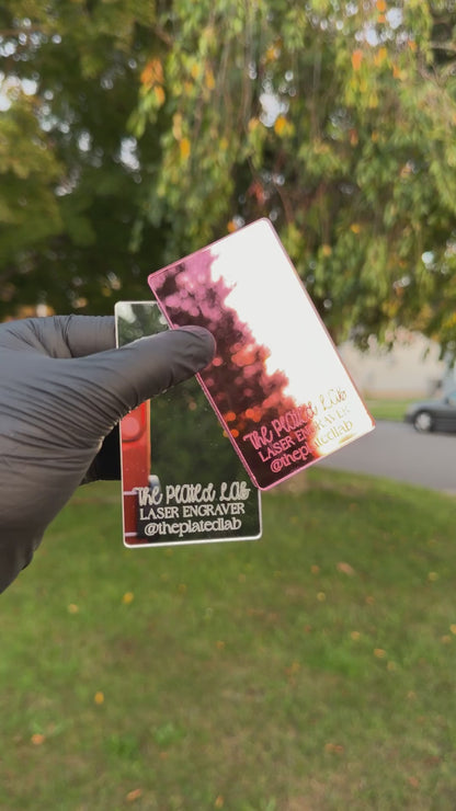 Video of pink and silver mirror business cards turning in the sunlight